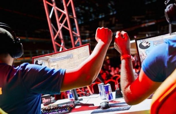 2 Gamers fist bumping each other during a competitive game of Counter Strike